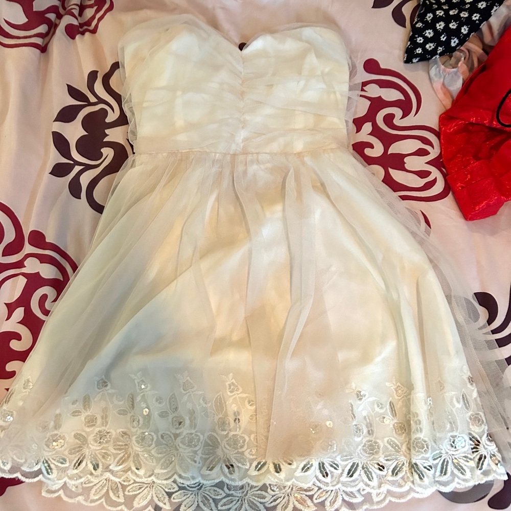 This is an off white, mini strapless dress.